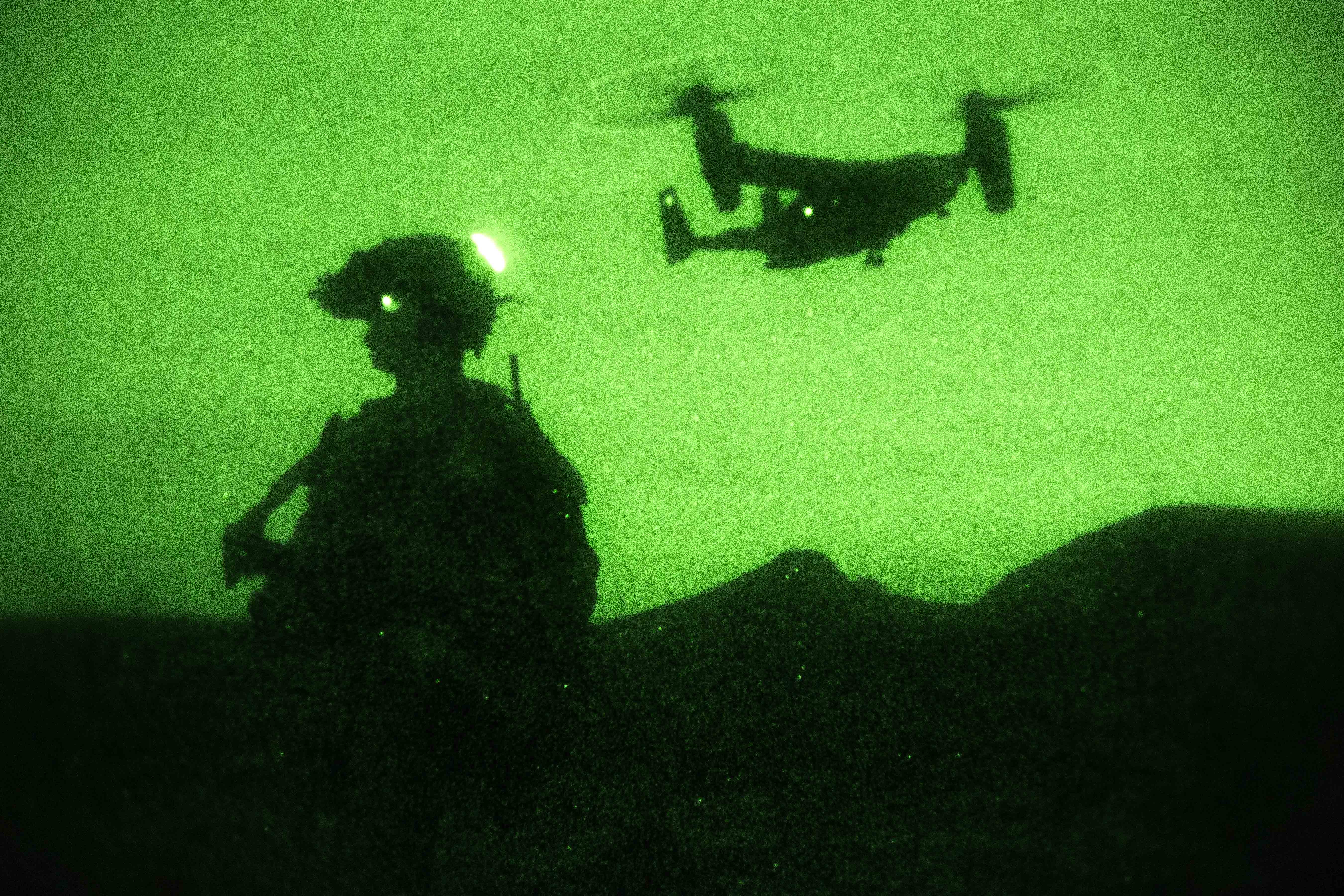 As seen through a nightvision device, a Marine provides security at