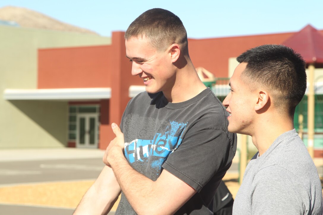 Cpl. Austin Worley, unmanned aerial vehicle operator, Unmanned Aerial Vehicle Squadron 1, and Lance Cpl. Jose D. Villalta, administration clerk, VMU-1, prepare to run alongside children at Joshua Tree Elementary during an adopt-a-school visit Dec. 4, 2013.


