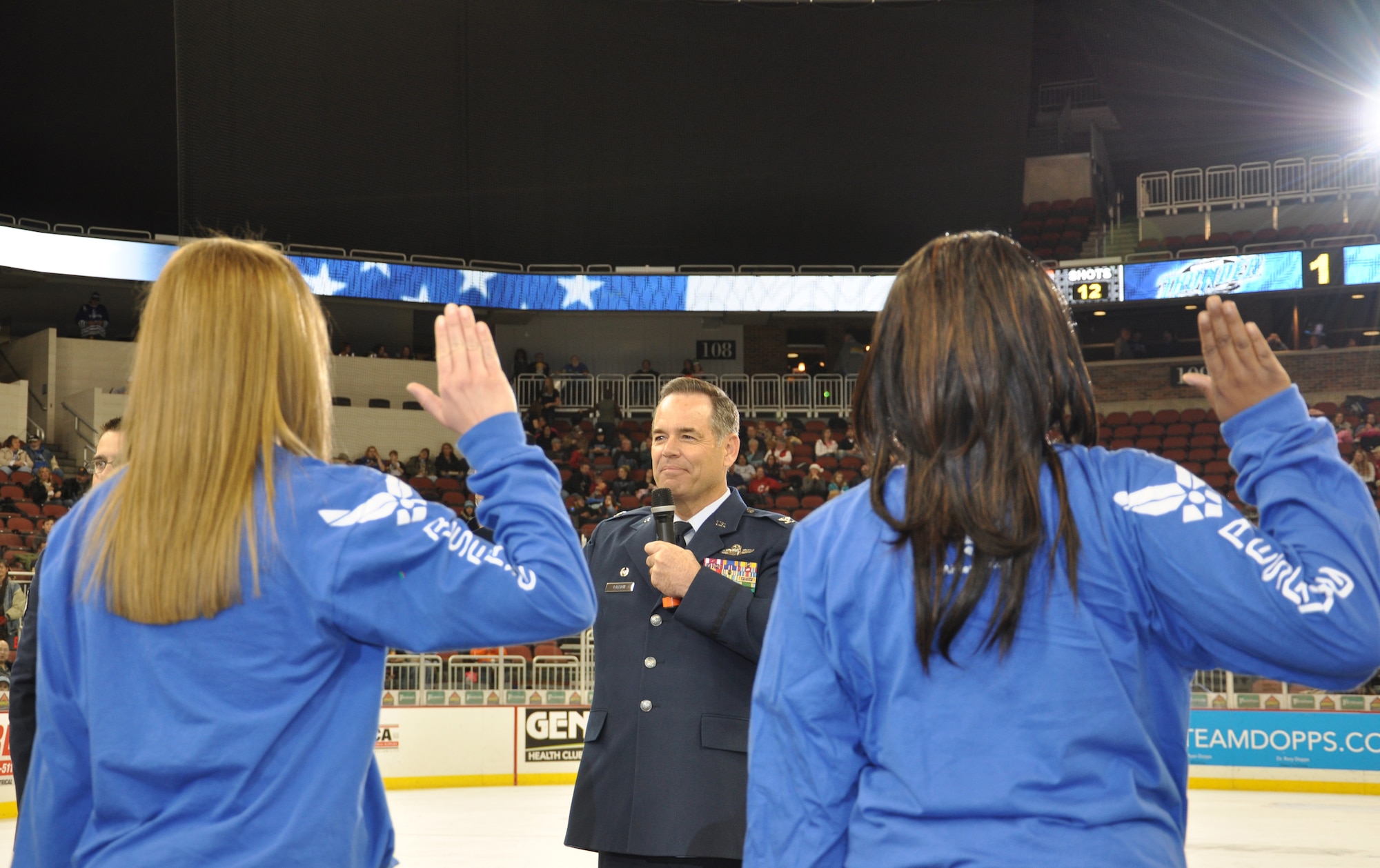 Colonel Mark S. Larson, 931st Air Refueling Group Commander, delivers the oath of enlistment during a swearing in ceremony of the first period intermission at the Wichita Thunder hockey game at Intrust Bank Arena, Dec. 7.  Six future 931st ARG members enlisted during the ceremony. (Air Force photo by Master Sgt. Brannen Parrish)
