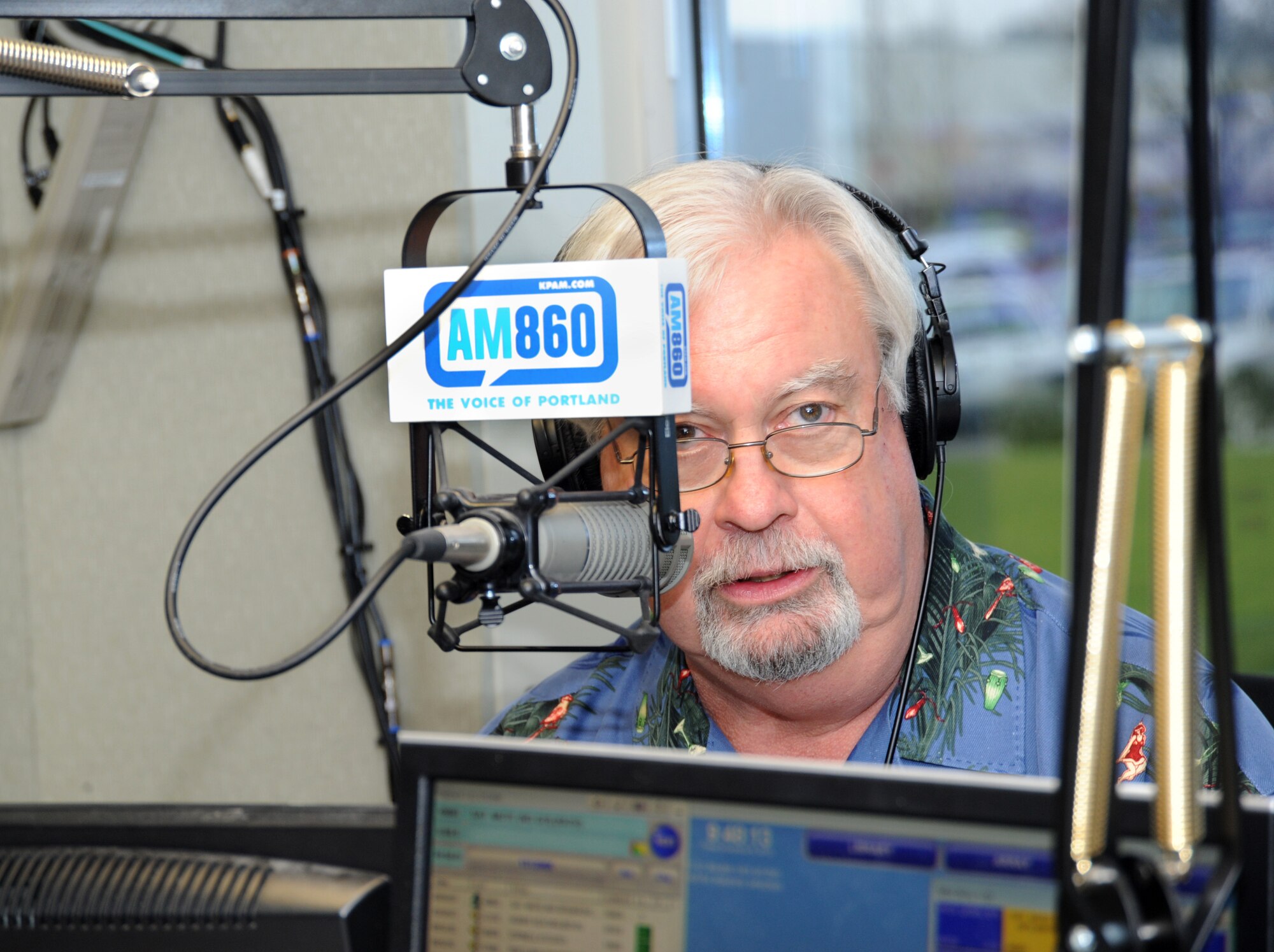 KPAM radio AM860 host Bob Miller talks to his radio audience during the Operation Santa Claus telethon program, Dec. 6, 2013. The 142nd Fighter Wing volunteers helped raise over 47,000 dollars during the final day of The Salvation Army fund raising event, which helps support veterans of Oregon and Southwest Washington. (Air National Guard photo by Tech. Sgt. John Hughel, 142nd Fighter Wing Public Affairs/Released)