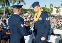 Tech. Sgt. Andrew Shepherd, right, 15th Aircraft Maintenance Squadron, is presented a flag by a Hickam Honor Guard member during the December 7th Remembrance Ceremony at Hickam Field, Dec. 7, 2013. Shepherd is the grandson of Hickam Field Attack survivor, Marion Shepherd, and received the flag in honor and recognition of his grandfather’s selfless service. Shepherd has been assigned to Hickam since August 2013 and served as a volunteer and honored guest at a Dec. 7, 1941, remembrance ceremony which paid homage to the 190 fallen men and women as well as the survivors.  (U.S. Air Force photo/Staff Sgt. Terri Paden)