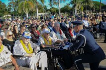 A Hickam Honor Guard member presents a U.S. flag to World War II veteran, Col. (ret ) Roy Bright, at the December 7th Remembrance Ceremony on Hickam Field, Dec. 7, 2013. Bright was a B-17 navigator assigned to Hickam Field at the time of the attack. At 99 years-old, Bright has never missed a December 7th  Remembrance Ceremony since 1946. The ceremony paid tribute to the 72nd Anniversary of the attack on Hickam Field Dec. 7, 1941, that claimed the lives of 190 Airmen and civilians. (U.S. Air Force photo/Staff Sgt. Terri Paden)