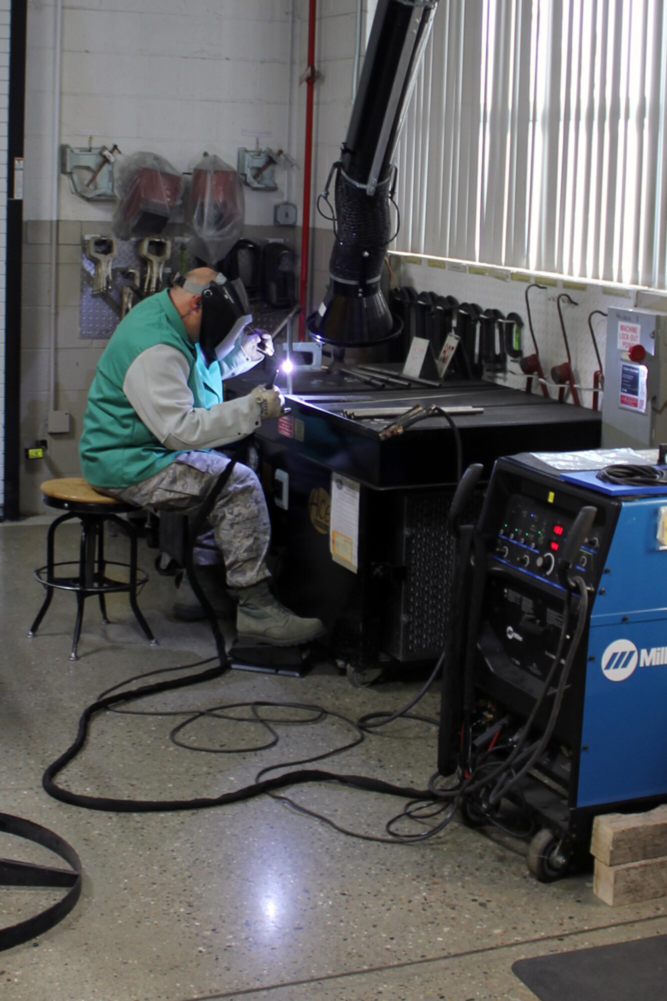 131207-Z-VA676-076 – TSgt. Mike Moale uses a TIG welder to join two pieces of metal during the fabrication of a part of an aircraft safety device at Selfridge Air National Guard Base, Mich., Dec. 7, 2013. Moale, who has served in the Navy, Air Force Reserve and Air National Guard, has been working as a welder and in related trades for 30 years. (U.S. Air National Guard photo by TSgt. Dan Heaton / Released)