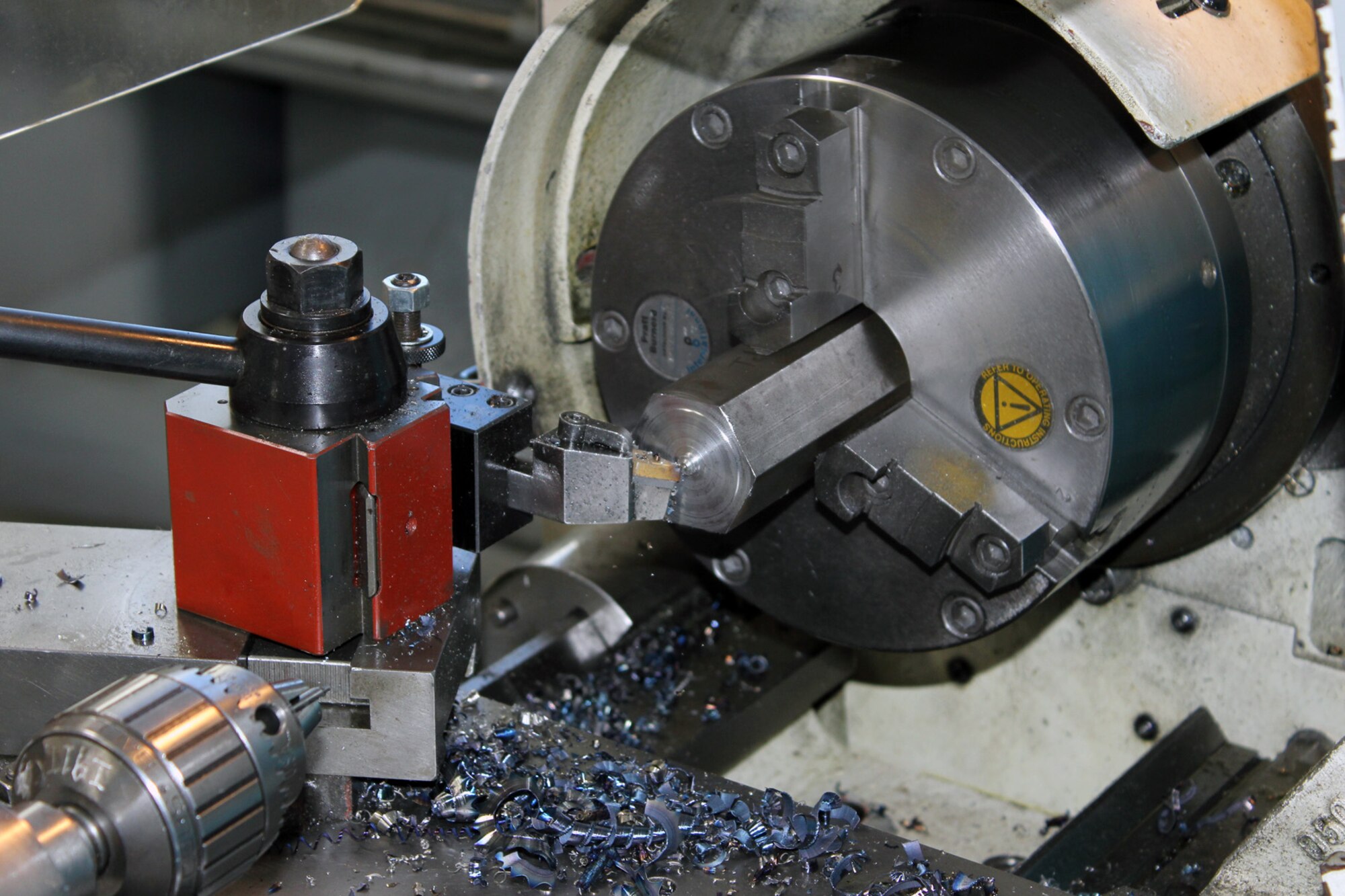 131207-Z-VA676-038 – Metal shavings pile up during the fabrication of an aircraft component in a lathe machine at Selfridge Air National Guard Base, Mich., Dec. 7, 2013. The lathe is located in the machine shop operated by the 191st Maintenance Squadron at Selfridge, which supports the operation of the KC-135 Stratotanker. (U.S. Air National Guard photo by TSgt. Dan Heaton / Released)