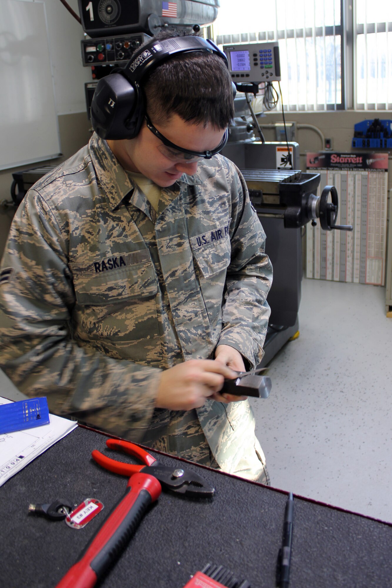 131207-Z-VA676-019 – Airman 1st Class Christopher Raska uses a file to remove any imperfections from an aircraft component he was fabricating at Selfridge Air National Guard Base, Mich., Dec. 7, 2013. A member of the 127th Wing for two years, Raska is a student at Ferris State University. (U.S. Air National Guard photo by TSgt. Dan Heaton / Released)