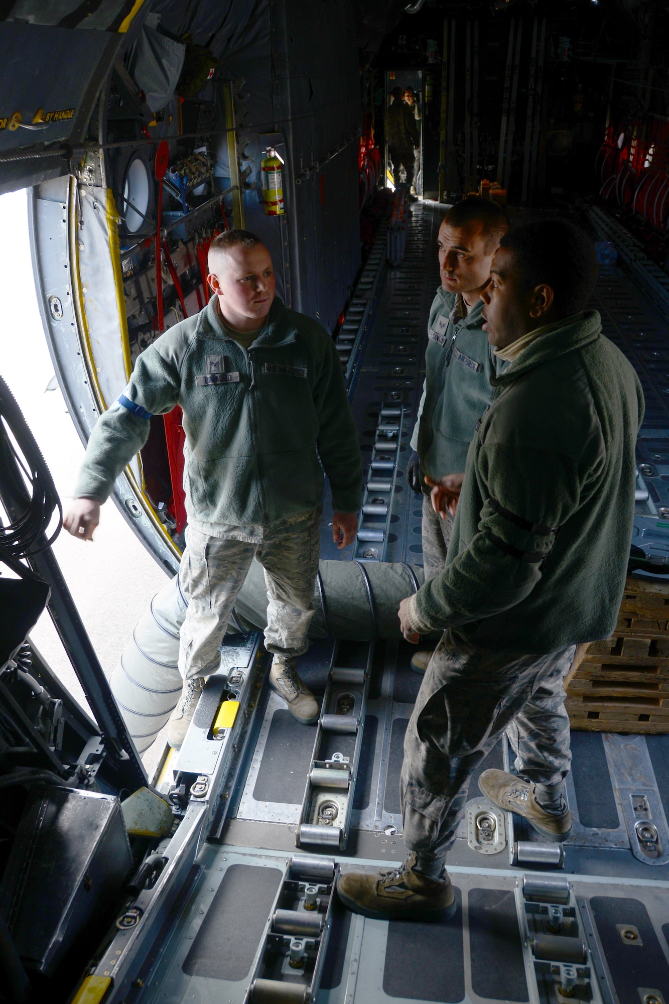 Senior Airman Robert DiMauro and Senior Airman Zachery Savluk, both crew chiefs assigned to the 103rd Airlift Wing, receive training from Tech. Sergeant Terrance Jones from the Kentucky Air National Guard, aboard a C-130H Hercules assigned to the 103rd Airlift Wing.  Instructors from the active duty Air Force are working with Airmen from the Kentucky and Minnesota Air National Guard to train maintainers at the Bradley Air National Guard Base.  (U.S. Air National Guard photo by Senior Airman Jennifer Pierce)