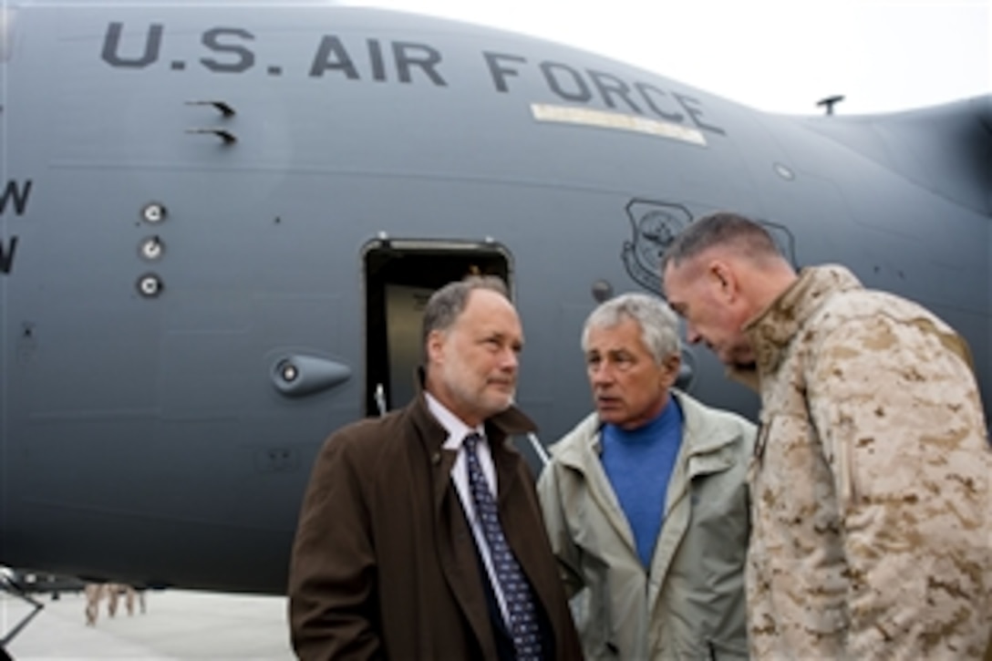 U.S. Defense Secretary Chuck Hagel greets U.S. Marine Corps Gen. Joseph F. Dunford Jr., right, commander of U.S. and international forces in Afghanistan, and James B. Cunningham, left, U.S. Ambassador to Afghanistan on arrival in Kabul, Afghanistan, Dec. 7, 2013. Hagel planned to visit with troops and commanders on the ground.