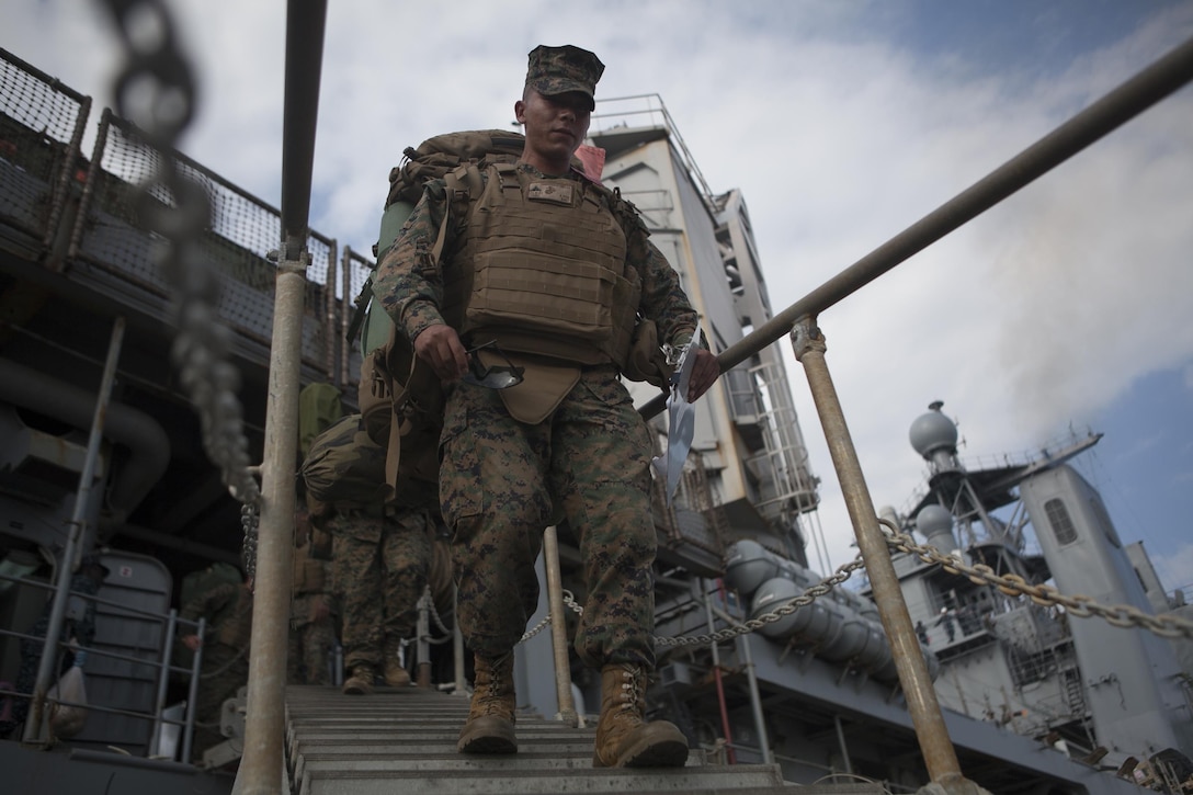 Lance Cpl. Juan J. Cabreramartinez, an administrative specialist with Combat Logistics Battalion 31, 31st Marine Expeditionary Unit, and a native of Long Beach, Calif., walks off the USS Germantown (LSD-42) here, Dec. 3, after spending more than two weeks assisting the Armed Forces of the Philippines in disaster relief efforts during Operation Damayan. Elements of the 31st MEU left Okinawa within 96 hours of receiving the mission, departing on Nov. 17. The 31st MEU is the Marine Corps force in readiness in the Asia-Pacific region and is the only continuously forward deployed MEU. 