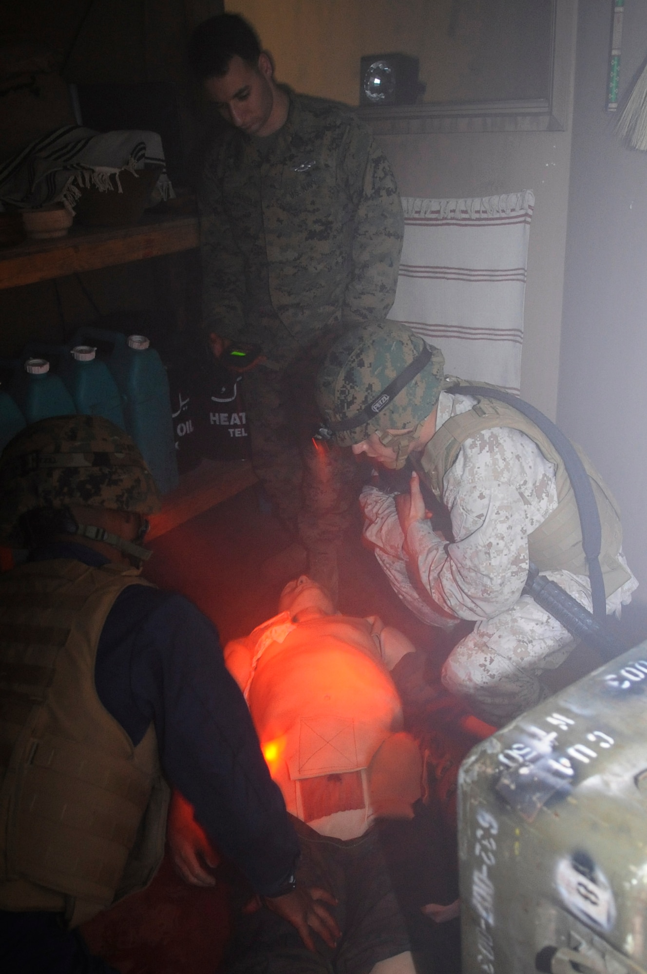 U.S. Marine Corpsmen from the III Marine Expeditionary Force participate in a medical simulation class to learn how to properly treat wounded teammates under any situation on Camp Hansen, Japan, Dec. 4, 2013.  The III MEF is forward-deployed and must be ready to perform life saving combat medical procedures in times of high stress and under fire. (U.S. Air Force photo by Senior Airman Marcus Morris)