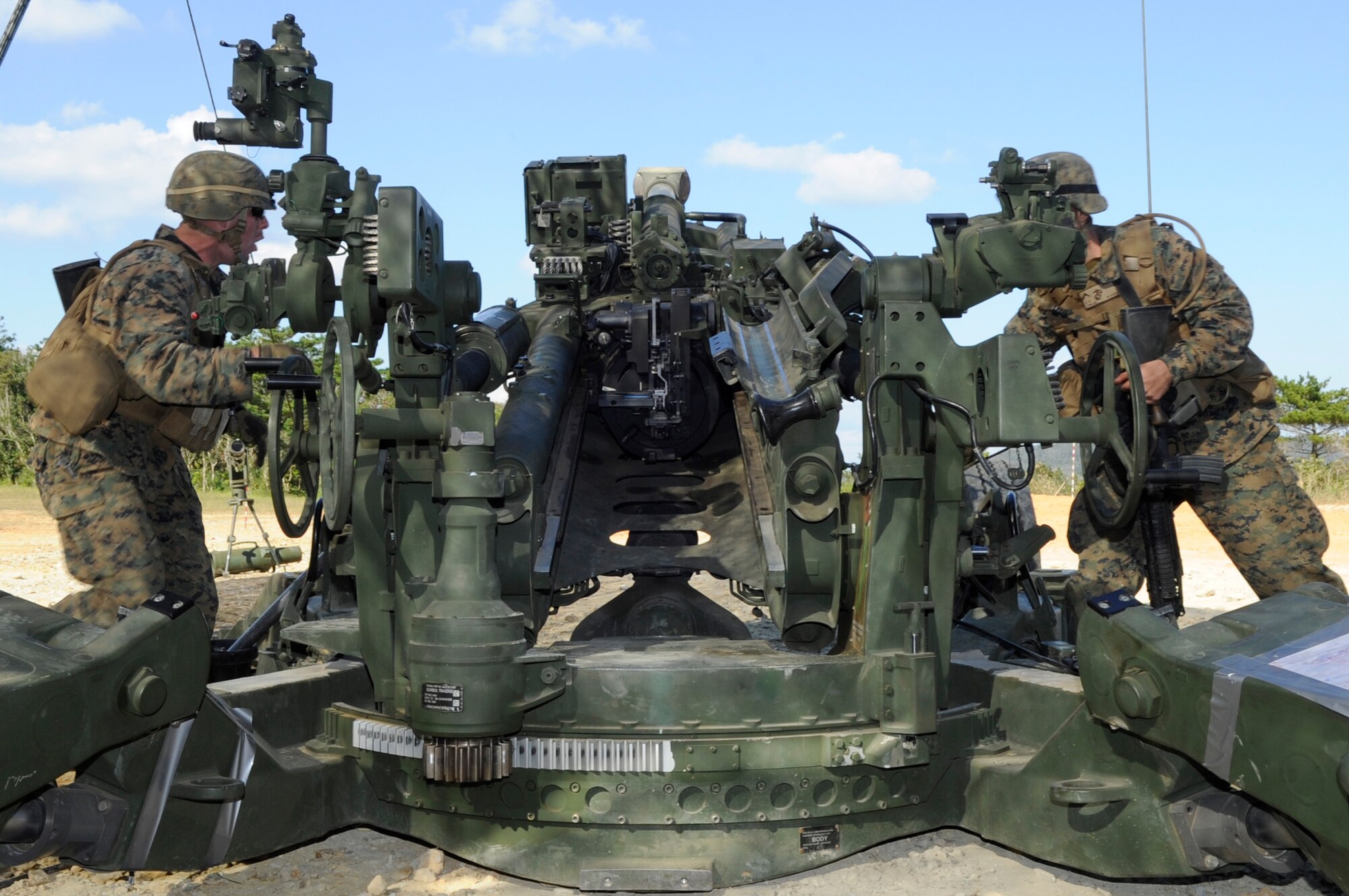 U.S. Marine Corps Lance Cpl. Nathan Best, and Pfc. Nicholas Lyons, Lima Battery, 3rd Battalion, 11th Marine Regiment artillery, demonstrate to U.S. and Japanese senior enlisted leaders firing an M777 lightweight howitzer on Camp Hansen, Japan, Dec. 4, 2013. The battalion is based at the Marine Corps Air Ground Combat Center Twentynine Palms, California, but is currently deployed to Okinawa, Japan as part of a unit deployment program. (U.S. Air Force photo by Senior Airman Marcus Morris)