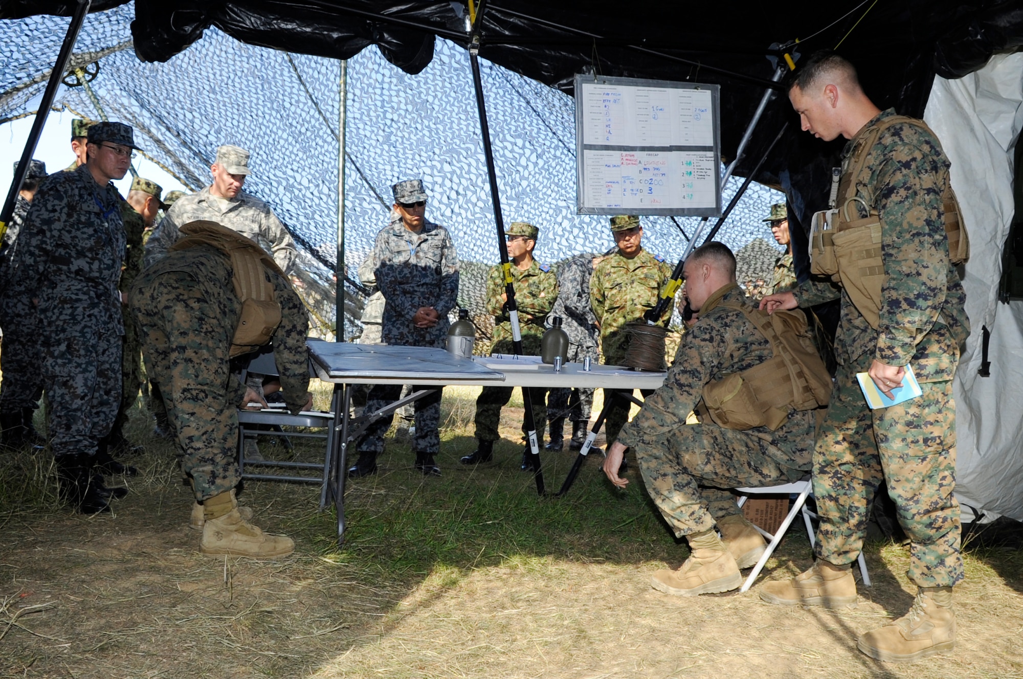 U.S. Marine Corpsmen from the Lima Battery, 3rd Battalion, 12th Marine Regiment sensors demonstrate to U.S. and Japanese senior enlisted leaders how they use sensor coordinates to call in artillery strikes on Camp Hansen, Japan, Dec. 4, 2013. The battalion is part of a unit deployment program that uses artillery units from across the Marine Corps to fill its three artillery batteries. (U.S. Air Force photo by Senior Airman Marcus Morris)