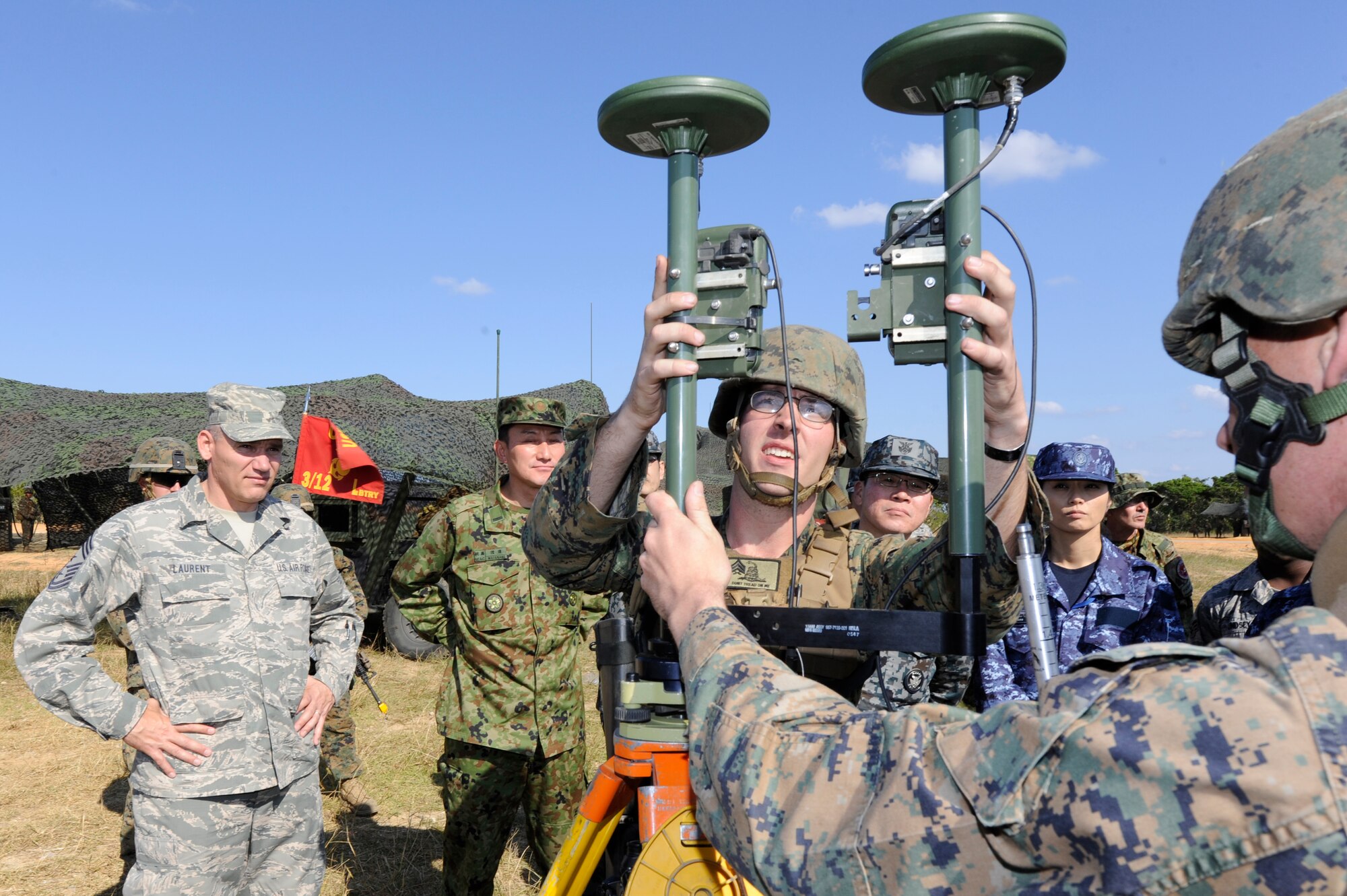 U.S. Marine Corps Staff Sgt. Jonathan Nicholas Flinchbaugh and Cpl. Michael Hurley, Lima Battery, 3rd Battalion, 12th Marine Regiment sensors, demonstrate to U.S. and Japanese senior enlisted leaders how they can plot map points with sensors on Camp Hansen, Japan, Dec. 4, 2013. Lima Battery provides direct support to the 3rd Marine Division in times of conflict. (U.S. Air Force photo by Senior Airman Marcus Morris)