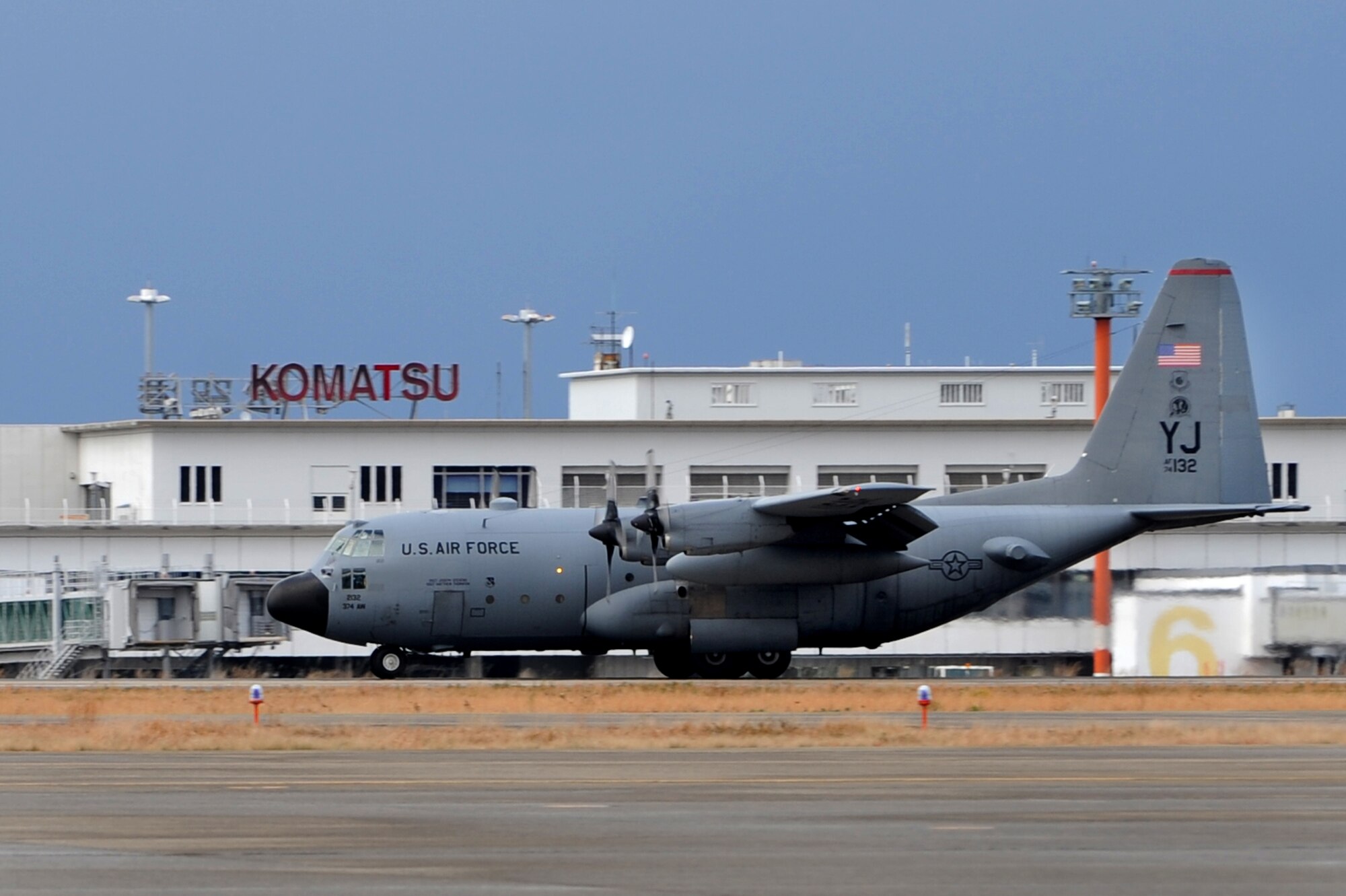 A U.S. Air Force C-130 Hercules aircraft taxis down a runway after touching down on Komatsu Air Base, Japan, Dec. 7, 2013. The C-130 arrived at Komatsu from Kadena Air Base, Japan, carrying Airmen that will participate in a week-long Aviation Training Relocation Program hosted by the Japanese Air Self Defense Force 6th Wing. (U.S. Air Force photo by Staff Sgt. Amber E. N. Jacobs)