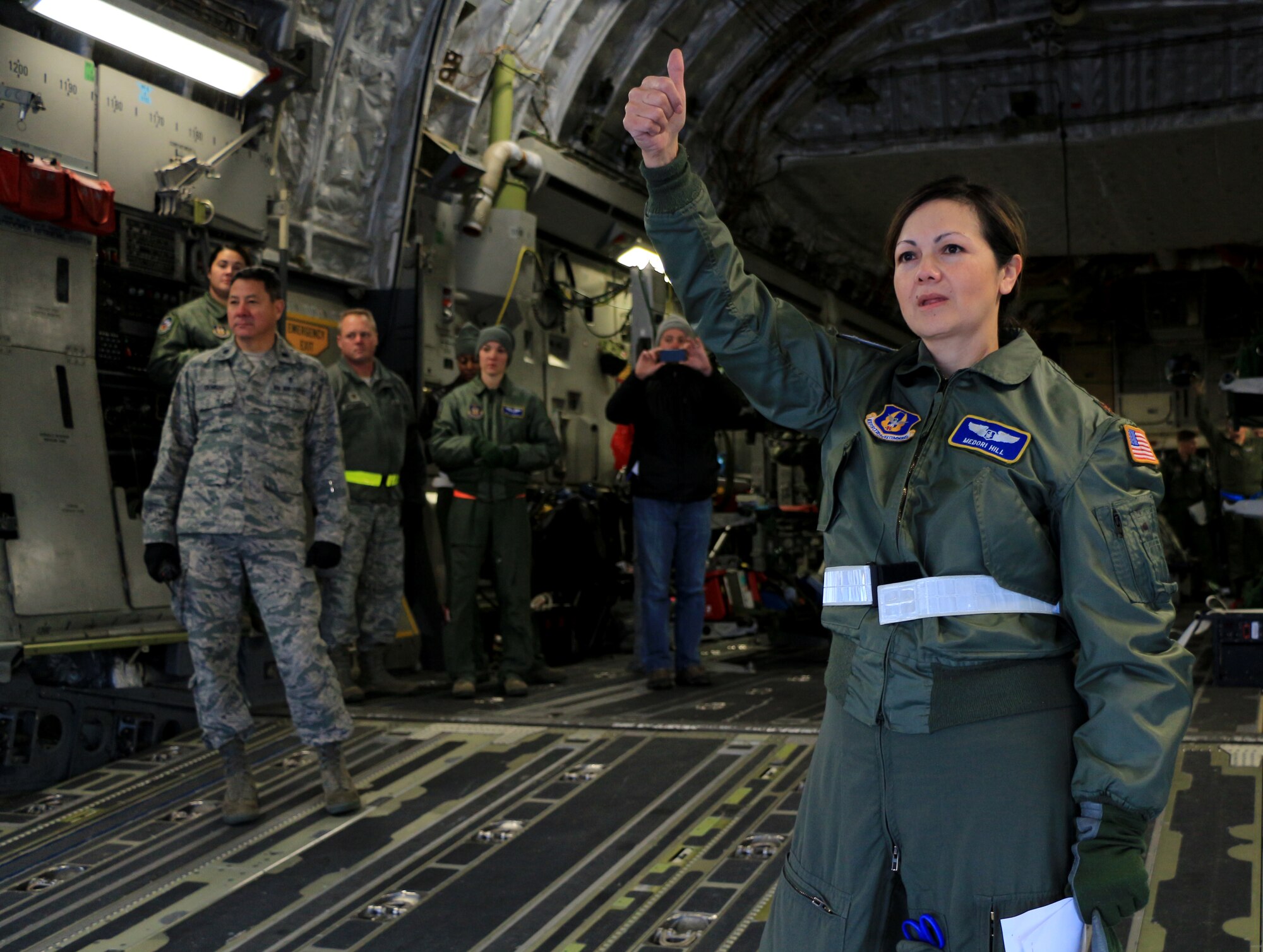 1st Lt. Naomi Warner, 446th Aeromedical Evacuation Squadron flight nurse, aids a Reservist who is simulating a distraught patient during a training flight on a C-17 Globemaster III Dec. 8. The training helps medical Reservists prepare for emergencies that may happen during real-life situations. (U.S. Air Force Reserve photo by Senior Airman Madelyn McCullough)