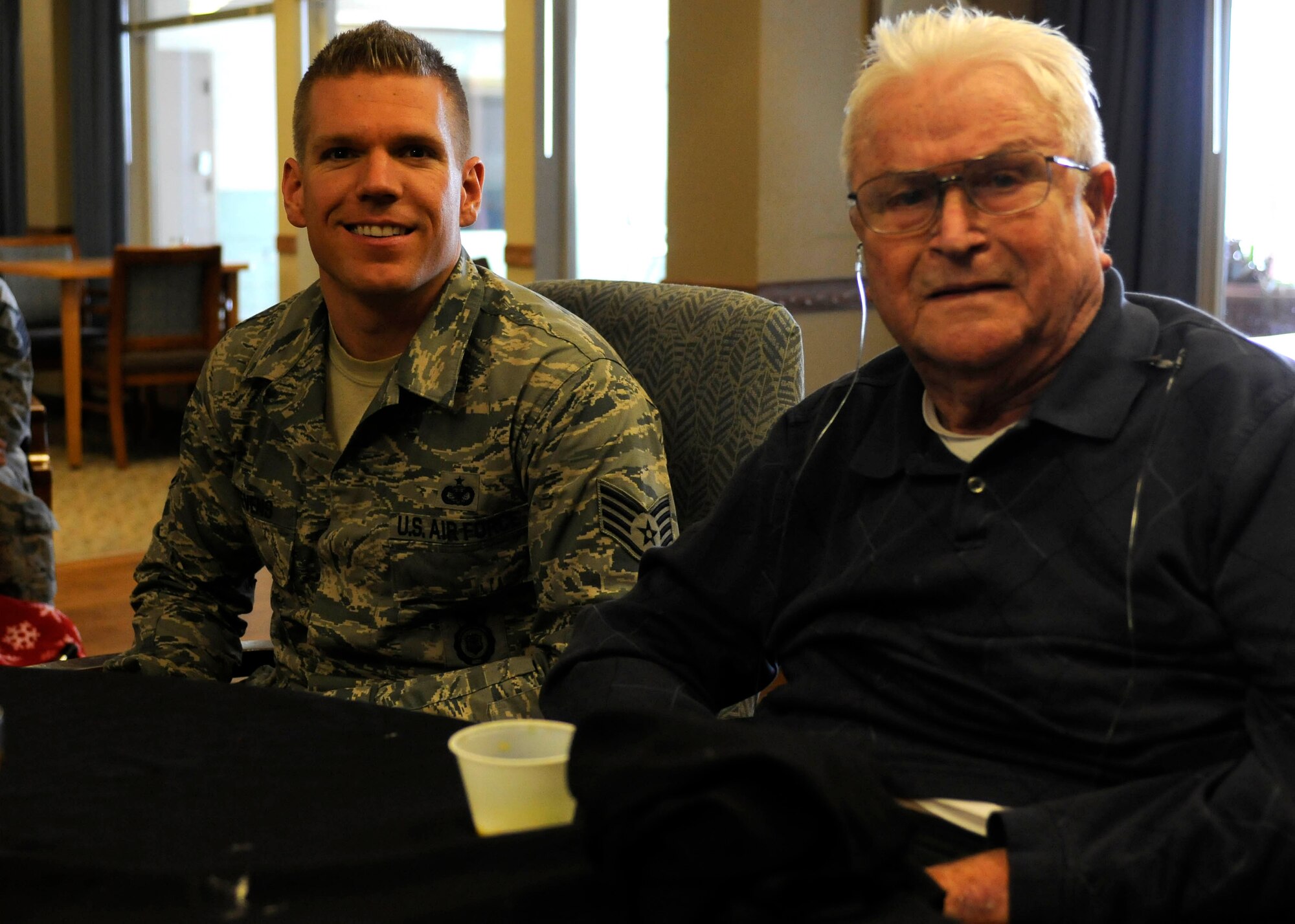 Staff Sgt. Zac Stevens poses for a picture with Johnny Paul during his visit to George Wahlen Veterans Home. (U.S. Air Force photo illustration/Senior Airman Allen Stokes)