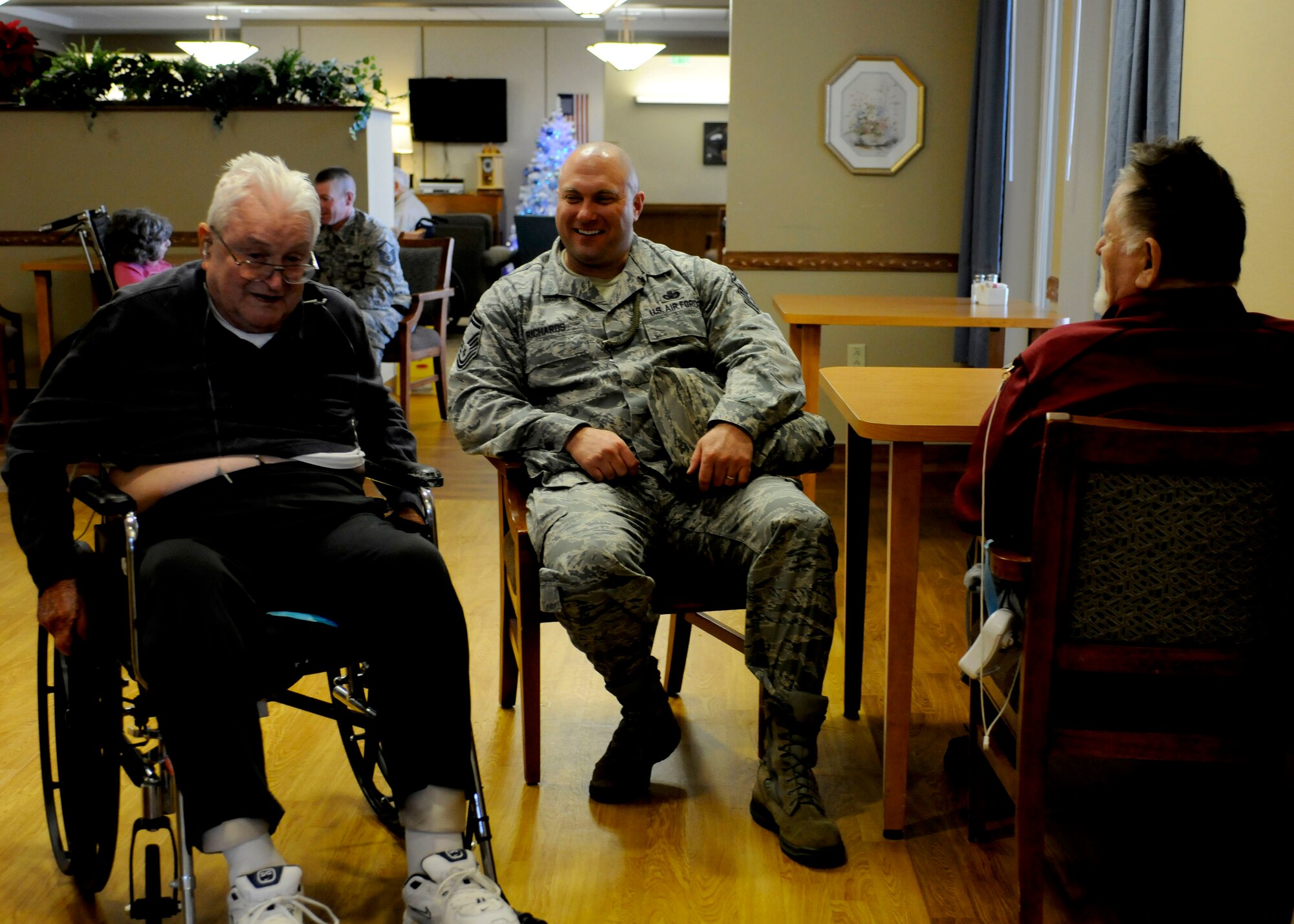 Senior Master Sgt. Robert Richards talks to Johnny Paul (left) and Allen Barney (right) during the reservists visit to George Wahlen Veterans Home. (U.S. Air Force photo illustration/Senior Airman Allen Stokes)