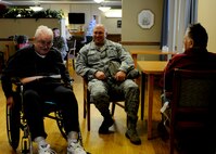 Senior Master Sgt. Robert Richards talks to Johnny Paul (left) and Allen Barney (right) during the reservists visit to George Wahlen Veterans Home. (U.S. Air Force photo illustration/Senior Airman Allen Stokes)