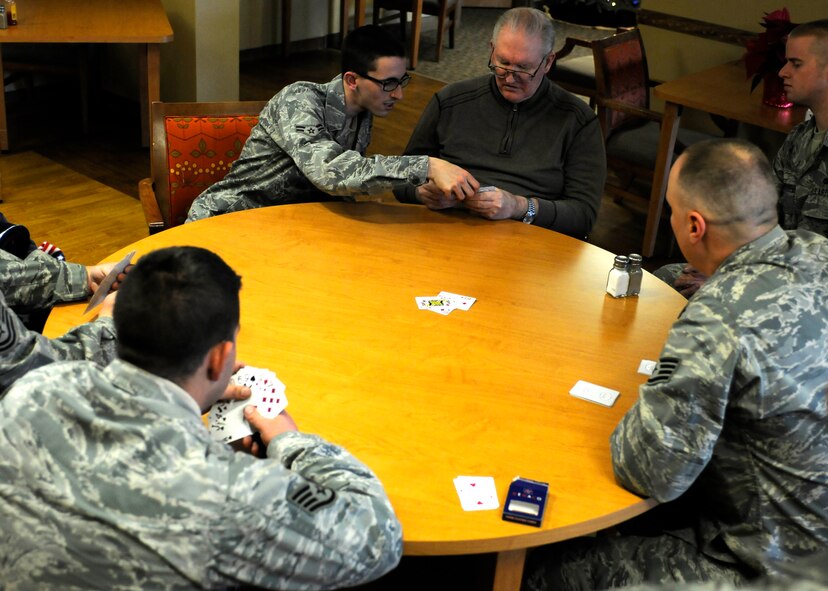 Harold Flanders and 419th Security Forces Airmen play a game of spades during the reservists visit to George Wahlen Veterans Home. (U.S. Air Force photo illustration/Senior Airman Allen Stokes)