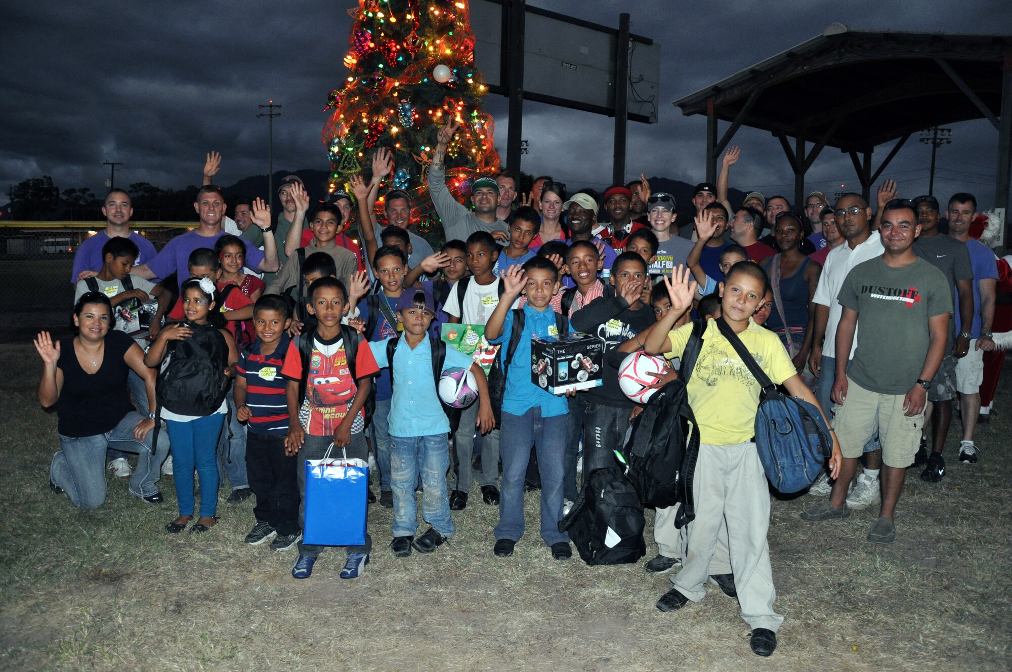 Honduran orphans and members of Joint Task Force-Bravo pose in front of the tree during Joint Task Force-Bravo's "Operation Holiday Blessing," at Soto Cano Air Base, Honduras, Dec. 6, 2013.  More than 300 Honduran orphans were treated to a day of activities, gifts, and holiday joy, provided by more than 200 volunteers from the Task Force.  (U.S. Air Force photo by Capt. Zach Anderson)