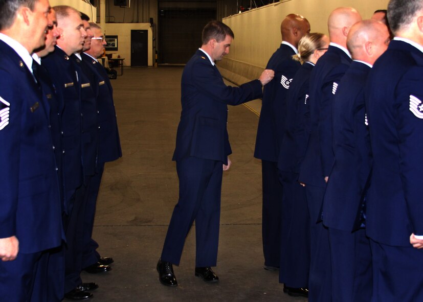 Maj. Justin Crump, 67th Aerial Port Squadron Logistics Readiness Officer, inspects service uniform to ensure they are in compliance with Air Force standards. (Courtesy photo/Tech. Sgt. Rahman Badarane)