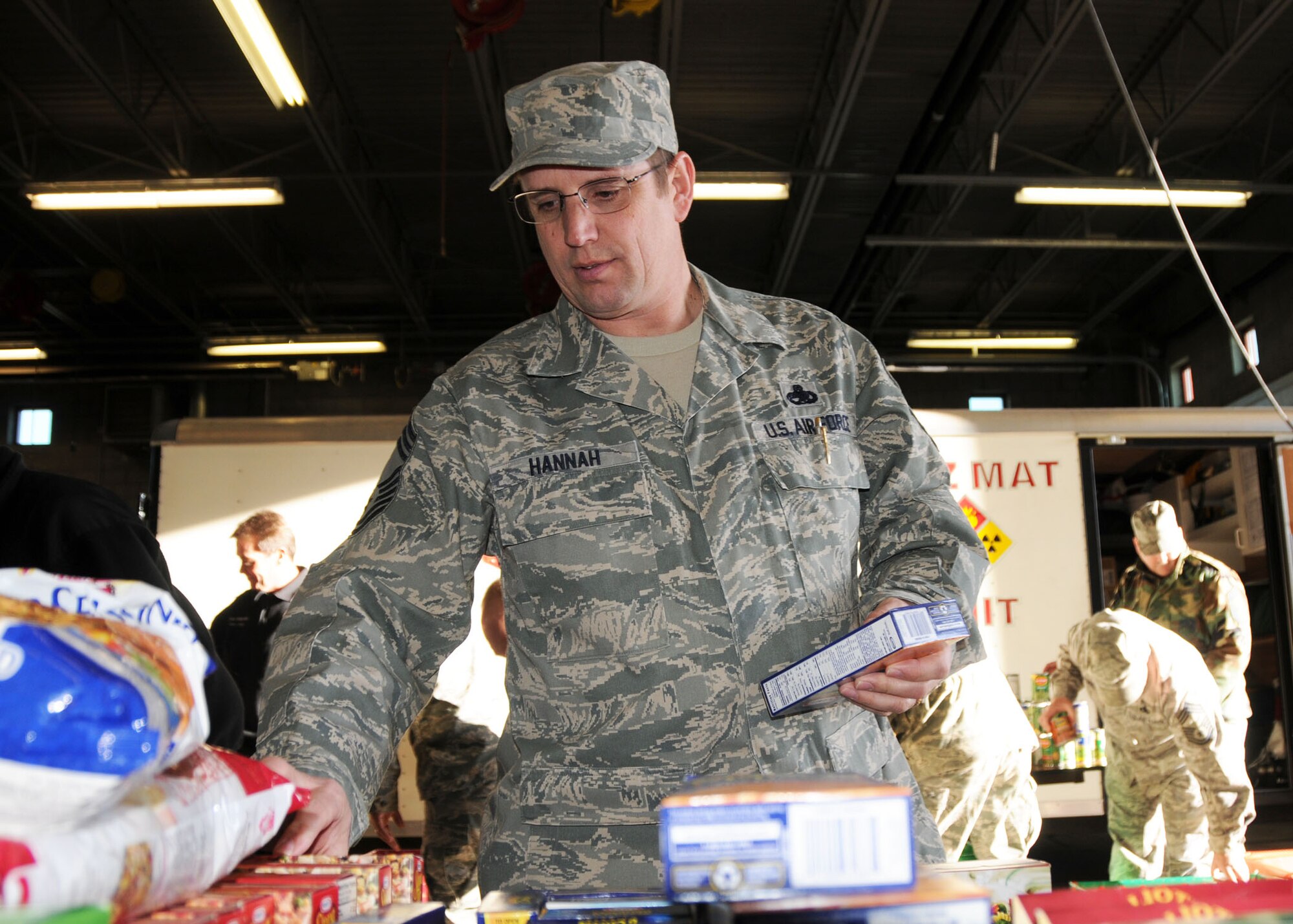 Chief Master Sgt. Roy Hannah sorts food collected and donated to the “Operation Giving Spirit” program by members of the Montana Air National Guard on Dec. 18, 2009. The food was boxed and delivered to needy Guard families. National Guard photo/Senior Master Sgt. Eric Peterson.