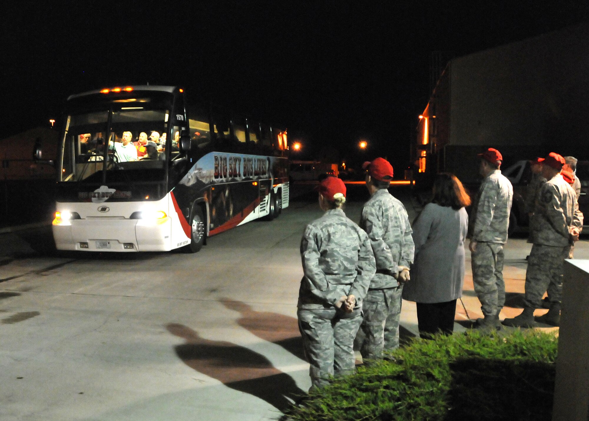 Members of the 219th RED HORSE Squadron wish deploying personnel well as they board a bus bound for Colorado to support flood relief efforts on Oct. 11, 2013.  (U.S. Air Force photo/Senior Master Sgt. Eric Peterson)


