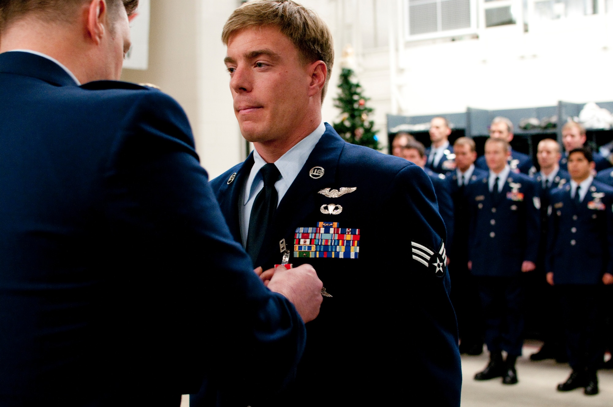 JOINT BASE ELMENDORF-RICHARDSON, Alaska -- Senior Airman Andrew J. Nichols, a pararescueman with the Alaska Air National Guard's 212th Rescue Squadron receives the Bronze Star Medal in a ceremony here Dec. 7, 2013. Nichols was awarded the Bronze Star Medal for his courageaous actions to save a wounded U.S. soldier under enemy fire in Afghanistan's Konar Valley on July 19, 2011. National Guard photo by Tech. Sgt. Jennifer Theulen.