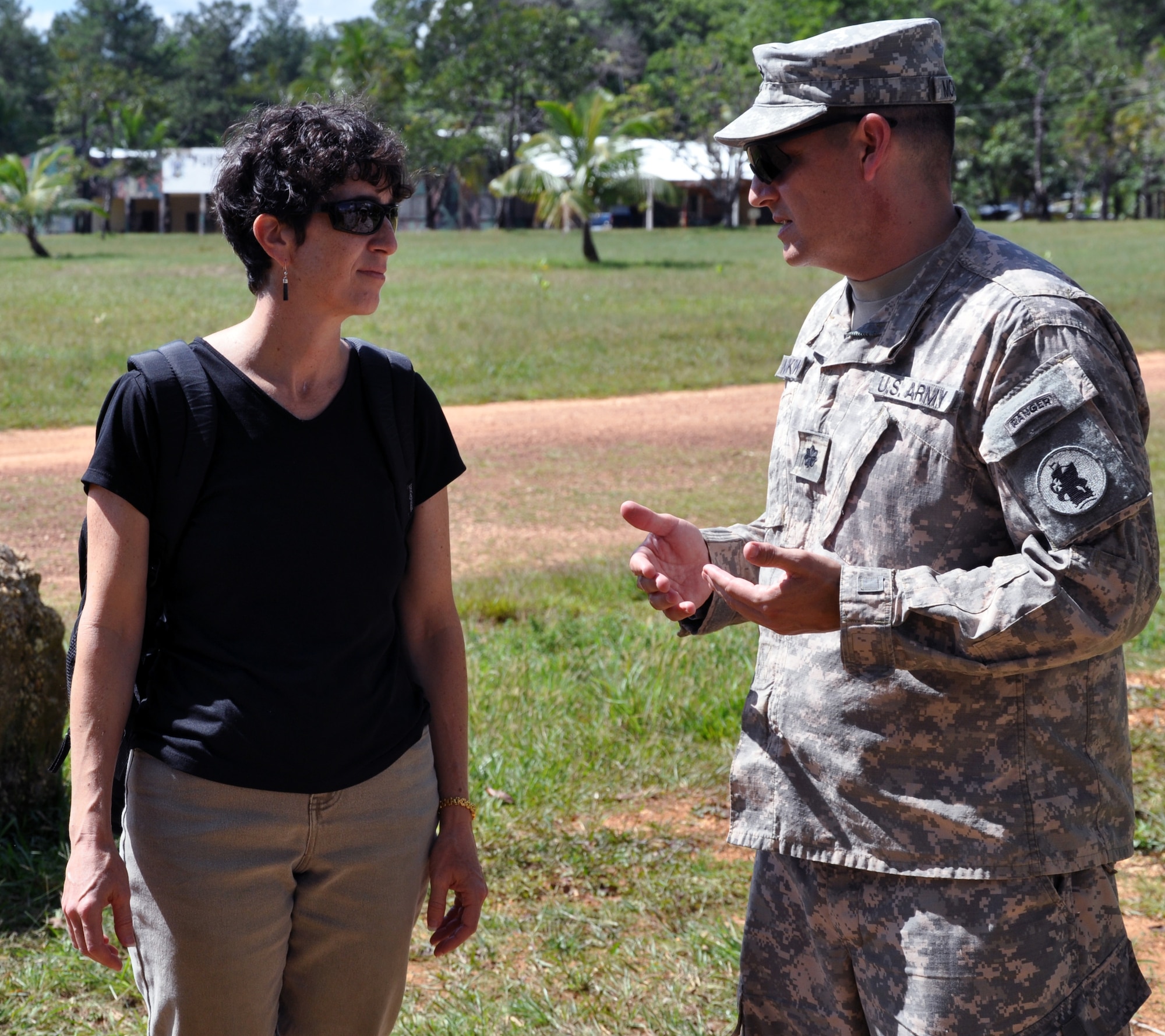U.S. Army Lt. Col. Alan McKewan discusses the work of the U.S. Southern Command Survey and Assessment Team with Julie Schechter Torres, Deputy Chief of Mission for the U.S. Embassy, during Joint Task Force-Bravo's Culminating Training Exercise (CULEX) at Mocoron, Honduras, Dec. 3, 2013.  More than 90 members of Joint Task Force-Bravo deployed to the Department of Gracias a Dios for the exercise.  (U.S. Air Force photo by Capt. Zach Anderson)