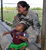 U.S. Army Capt. Diane Klescewski weighs a Honduran infant during a Medical Readiness Training Exercise as part of Joint Task Force-Bravo's Culminating Exercise (CULEX), Dec. 3, 2013.  For the CULEX, more than 90 members of Joint Task Force-Bravo deployed to the Department of Gracias a Dios, Honduras, to conduct both real-world and exercise operations.  (U.S. Air Force photo by Capt. Zach Anderson)