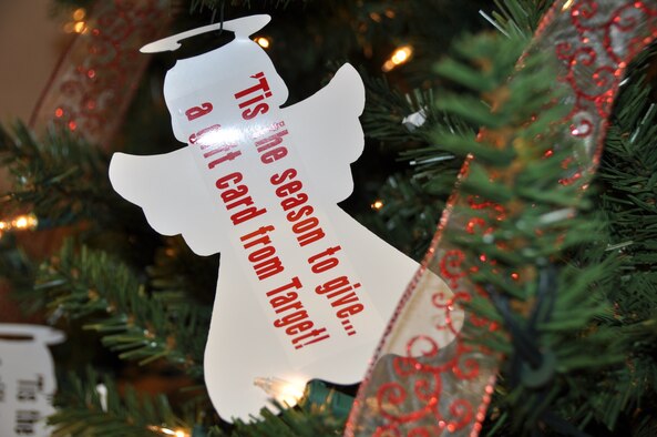 An ornament hangs from the Angel Tree sponsored by the 911th Airlift Wing Airman and Family Readiness Center, inside the dining facility at the Pittsburgh International Airport Air Reserve Station, Dec. 8, 2013. The Angel Tree allows 911th AW members to take an ornament and donate gift cards to   other 911th AW Airmen facing financial hardships. On the front of each ornament is a statement to designate gift cards that Airman and Family Readiness would like to collect.  All donations for the angel tree are due December 18. (U.S. Air Force photo by Senior Airman Marjorie A. Bowlden)