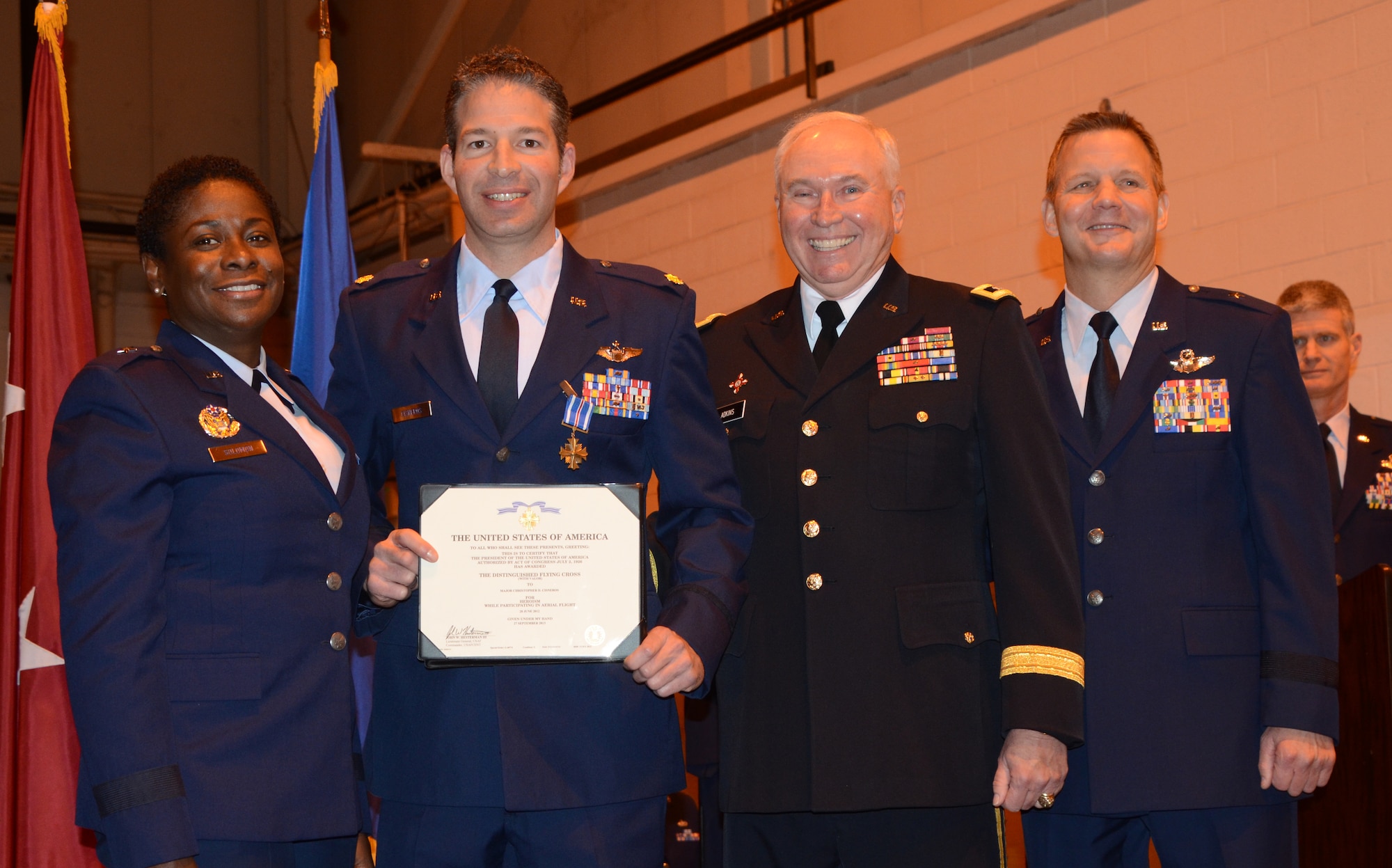 Maj. Chris Cisneros, 104th Fighter Squadron Instructor Pilot, is awarded the Distinguised Flying Cross for duty performed while deployed to Southwest Asia.  The award was given during a ceremony at Warfield Air National Guard base on December 8, 2013.  (Air National Guard photo by TSgt. David Speicher/RELEASED)