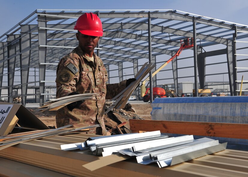 Air Force Senior Airman Deangelo Law, 557th Expeditionary Rapid Engineer Deployable, Heavy Operations Repair Squadron Engineer, prepares building supplies for the new fitness center at an undislosed location in Southwest Asia, Dec. 5, 2013. The new fitness center will be equipped with full lines of free weight equipment, selectorized weight equipment, cardio equipment, two indoor basketball courts, and a designated multi-purpose room.  (U.S. Air Force photo by Staff Sgt. Michael Means/Released)