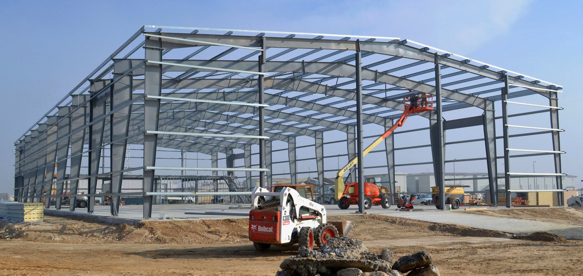 Airmen from the 557th Expeditionary Rapid Engineer Deployable, Heavy Operations Repair Squadron Engineer, work on construction of a new fitness center at an undisclosed location in Southwest Asia, Dec. 5, 2013. The fitness center is scheduled to be complete by April 2014. (U.S. Air Force photo by Tech. Sgt. Colleen Urban/Released)