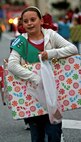 Girl Scout Alyssa Otto, 10, dressed as a present, walks in the annual Camp Kinser Christmas Parade and Tree Lighting Ceremony, Dec. 4, handing out candy along the way.