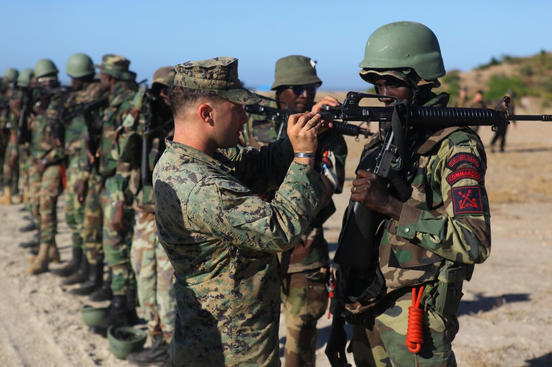 Sgt. James Thonus, an assistant team chief with Special-Purpose Marine Air-Ground Task Force Africa 13, checks the bolt and bore of a Senegalese Companie de Fusilier Marine Commando’s M16 prior to firing in Thiès, Senegal, Nov. 25, 2013. During the first week of the task force’s fourth month-long engagement in Senegal this year, the Marines focused on basic and combat marksmanship skills.