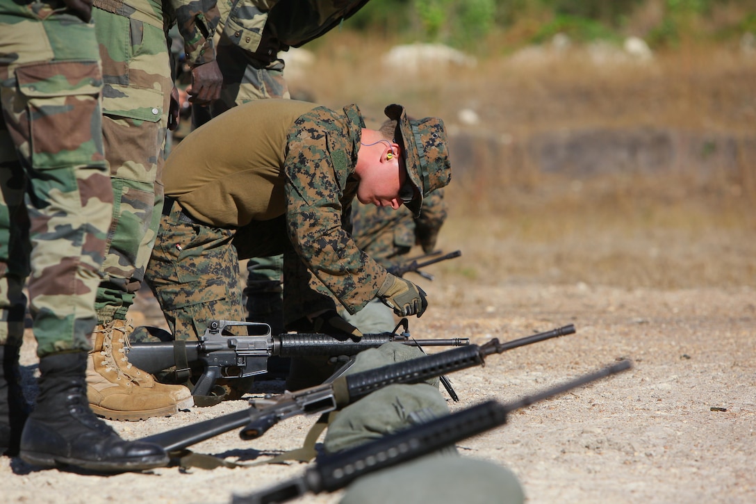 Cpl. Skyler Bowden, a radio operator and marksmanship coach from Baltimore with Special-Purpose Marine Air-Ground Task Force Africa 13, adjusts the front-sight post of a Senegalese Companie de Fusilier Marine Commando’s M16 while zeroing the weapon’s battle sight on the range in Thiès, Senegal, Nov. 25, 2013. During the first week of the task force’s fourth month-long engagement in Senegal this year, the Marines focused on basic and combat marksmanship skills.