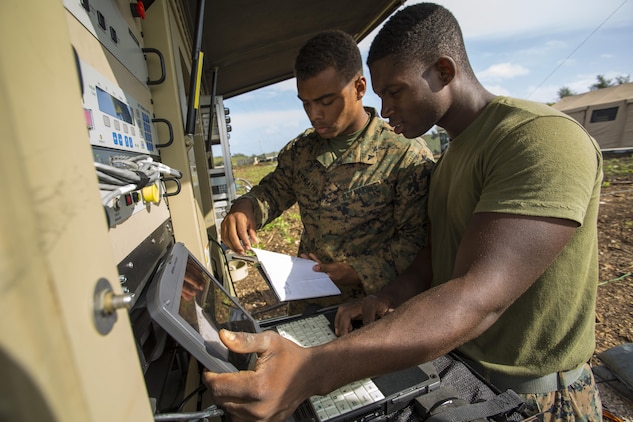 Lance Cpls. Sterling Meriweather, left, and Montrell Martin Jr. conduct a maintenance test on the wireless point-to-point link Dec. 2 at Tinian’s North Field during Exercise Forager Fury II to ensure the equipment is running properly. FF II is a joint exercise designed to employ and assess combat power generation in a deployed and austere environment. Meriweather and Martin are ground mobile forces communication operators with Marine Wing Communication Squadron 18, Marine Air Control Group 18, 1st Marine Aircraft Wing, III Marine Expeditionary Force. 

