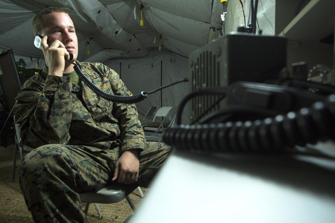 Lance Cpl. James Hughes communicates using a PRC-117 Dec. 2 at Tinian's North Field during Exercise Forager Fury II. FF II is a joint exercise designed to employ and assess combat power generation in a deployed and austere environment. Hughes is a field radio operator with Marine Wing Communication Squadron 18, Marine Air Control Group 18, 1st Marine Aircraft Wing, III Marine Expeditionary Force.  