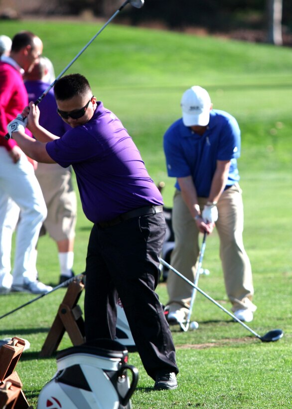 Hai Nguyen, an injured Marine with Wounded Warrior Battalion West, tees off at Taylormade the Kingdom in Carlsbad, Calif., Nov. 26, 2013. The Kingdom provides the injured Marines one-on-one instructional lessons on how to improve on the green.
