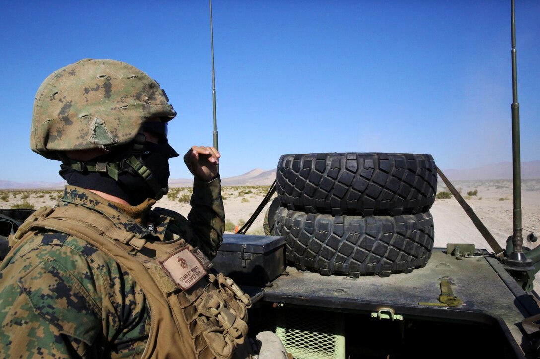 ARMY NATIONAL TRAINING CENTER FORT IRWIN, Calif. - Corporal Stephen Womer, Light Armored Vehicle Repairman, Headquarters and Service Company, 1st Light Armored Reconnaissance Battalion, and a native of New Castle, Del., scans the area while on a convoy during a weeklong field exercise here, during Nov. 18 to Nov. 24, 2013. Lieutenant Col. Gilbert Juarez, 1st LAR commanding officer, and a native of San Diego, said training on an Army base allows Marines and soldiers to learn from one another how to conduct training. The Marines conducted a 175 mile road march from their home in Camp Pendleton to Fort Irwin to use the Army base’s training facilities.
