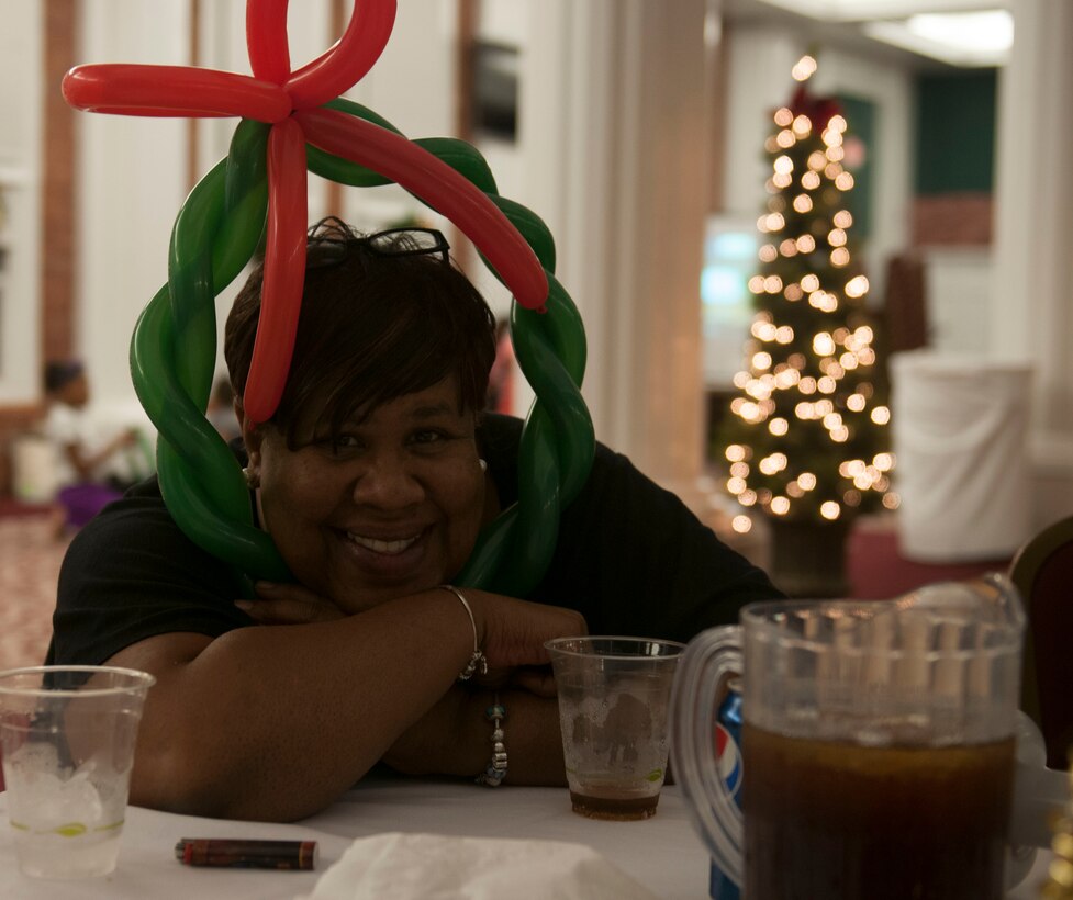 Sandra Blackmon, the command secretary for the 6th Marine Corps District, poses for a picture during the 6th district holiday party, Dec. 6, 2013. The Marines and families of the 6th district all gathered together to celebrate the holidays and enjoy each other’s company. (Marine Corps Photo by Lance Cpl. Stanley Cao)