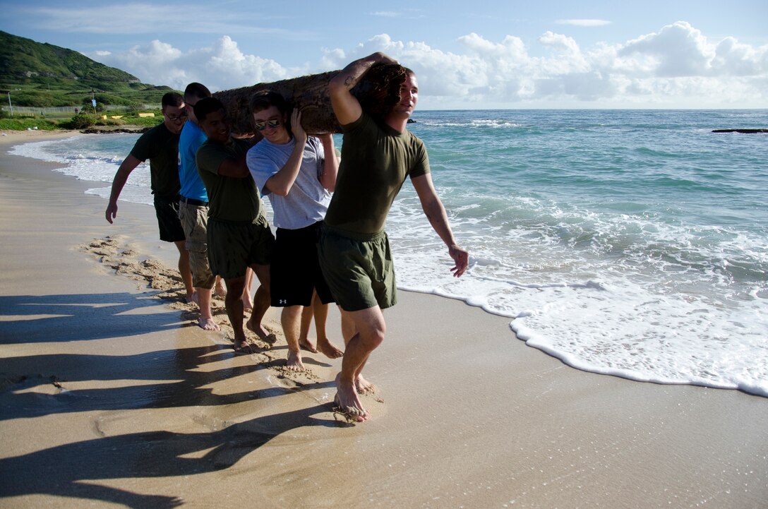 Young Marines and Marines from Headquarters Battalion and Marine Corps Air Station Kaneohe Bay help carry a log. More than 20 Young Marines from units in Florida, Kentucky and Washington joined the Pyramid Rock Young Marines and active-duty Marines to clean Fort Hase Beach, Dec. 4, 2013. Young Marine units annually travel to Hawaii to commemorate the anniversary of the Dec. 7 attacks by participating in a parade and wreath laying. This year they also participated in the basewide clean-up, Malama Ka Aina. Young Marine Sgt. Maj. Dakota Richter, the National Young Marine of the Year, from Florence, Ky., said the beach clean-up was the best form of community service and the group is grateful for the base’s hospitality. Young Marine Sgt. Maj. Storme DiGiovanni, 17, of Kailua, said the clean-up was a great opportunity for the Young Marines to come together for an activity, especially helping preserve the nature of Hawaii’s beaches. (U.S. Marine Corps photo by Kristen Wong)