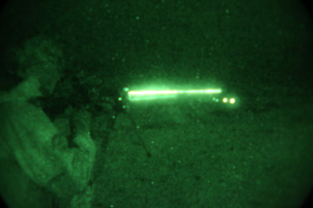 Lance Cpl. Tyler Smith, scout, Delta Company, 1st Light Armored Reconnaissance Battalion, and a native of Oklahoma City, fires his rifle at unknown distance targets at night during a weeklong field exercise here Nov. 18 through 24, 2013. The scouts have a hard time with night shoots because the targets become hard to pick out. Lance Cpl. Eric Bernes, an LAV crewman with Delta Co., said they have to adapt and overcome to accomplish the mission.