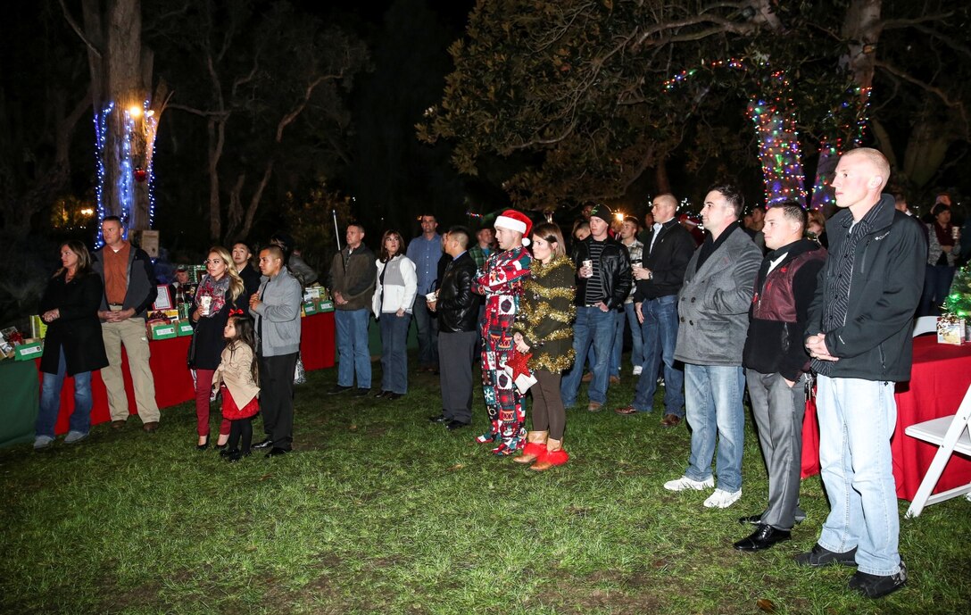 Marines, sailors and their families listen to Lt. Col. John R. O’Neal, commanding officer, 15th Marine Expeditionary Unit, during the unit’s holiday party at the San Diego Botanical Gardens in Encinitas, Calif., Dec. 6. During the party, families enjoyed food, Santa and an ugly sweater contest. (U.S. Marine Corps photo by Cpl. Emmanuel Ramos)