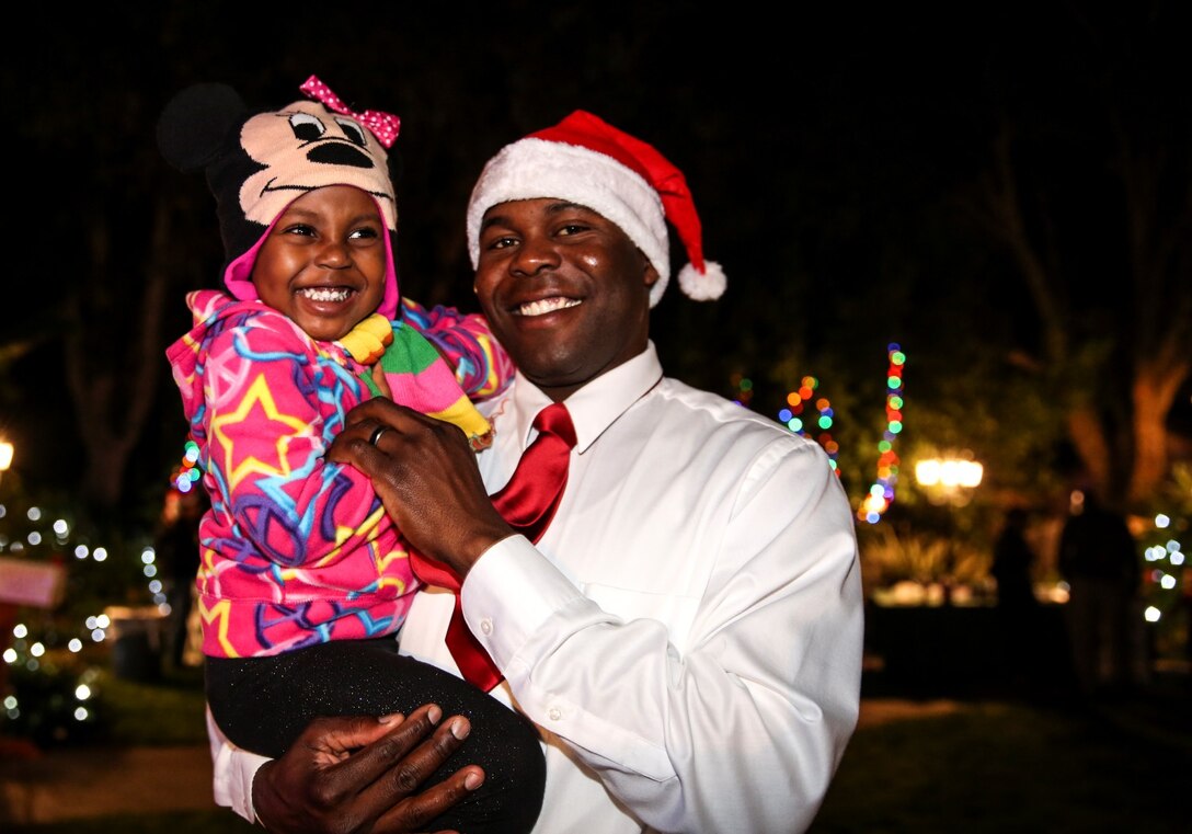 Sergeant Kenton A. Williams, motor transportation chief, 15th Marine Expeditionary Unit, poses for a photo with his daughter during the unit’s holiday party at the San Diego Botanical Gardens in Encinitas, Calif., Dec. 6. During the party, families enjoyed food, Santa and an ugly sweater contest. Williams, 28, is from Aurora, Colo. (U.S. Marine Corps photo by Cpl. Emmanuel Ramos)