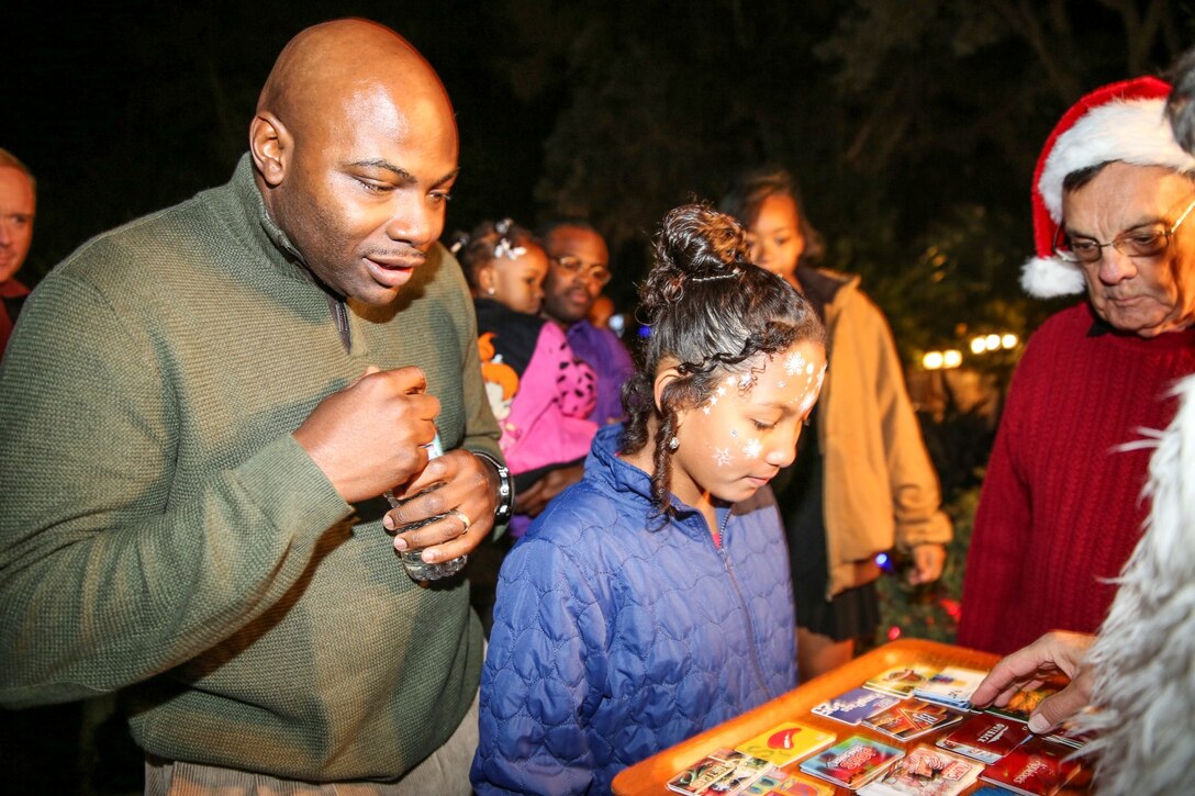 Gunnery Sgt. Treneil Smith, logistics chief, 15th Marine Expeditionary Unit, picks a gift card during the unit’s holiday party at the San Diego Botanical Gardens in Encinitas, Calif., Dec. 6. During the party, families enjoyed food, Santa and an ugly sweater contest. (U.S. Marine Corps photo by Cpl. Emmanuel Ramos)
