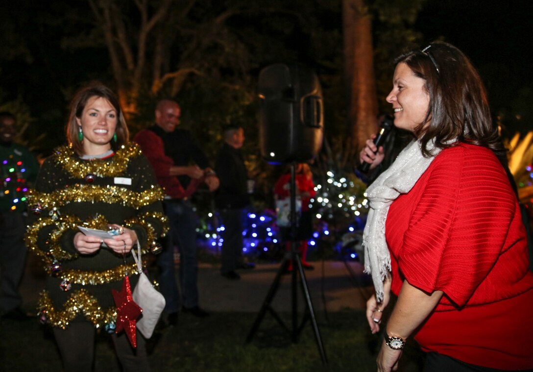 Nori Jackson, right, family readiness officer, announces Capt. Johanna Ciezczak, force protection officer, both with the 15th Marine Expeditionary Unit, as the winner of the ugly sweater contest during the unit’s holiday party at the San Diego Botanical Gardens in Encinitas, Calif., Dec. 6. During the party, families enjoyed food, Santa and an ugly sweater contest. Ciezczak, 27, is from Chicago. (U.S. Marine Corps photo by Cpl. Emmanuel Ramos)