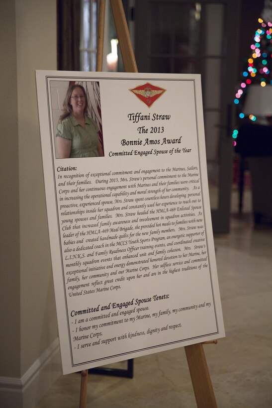 A poster displayed announces the Committed and Engaged Spouse of the Year and recipient of the first Bonnie Amos Award at a holiday party aboard Marine Corps Air Station Miramar, Calif., Dec. 6. Major General Steven Busby, commanding general of 3rd Marine Aircraft Wing (MAW), hosted the party to bring people together to recognize committed and engaged spouses and leaders.