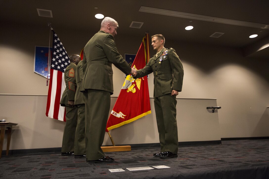 I Marine Expeditionary Forces commanding general, Lt. Gen. John A. Toolan shakes Maj. Robb McDonalds hand after pinning the Silver Star on his uniform. McDonald receives the Silver Star, the nation’s third-highest combat valor award, for his role in repelling an enemy attack inside Camp Bastion, Afghanistan. McDonald was serving as the executive officer of Marine Attack Squadron 211, III Marine Aircraft Wing. The ceremony took place at the 1st Marine Special Operations Battalion command building at Camp Pendleton Dec. 9. 

According to the award citation on Sept. 14, 2012 15 insurgents infiltrated Camp Bastion and attacked the coalition forces stationed there. McDonald took charge after the commanding officer, Lt. Col. Christopher Raible, was mortally wounded. He risked his life to lead Marines away from a building that could have become a death trap had the troops remained there. He later shot and killed one attacker and directed two helicopter attacks that killed several other insurgents.
