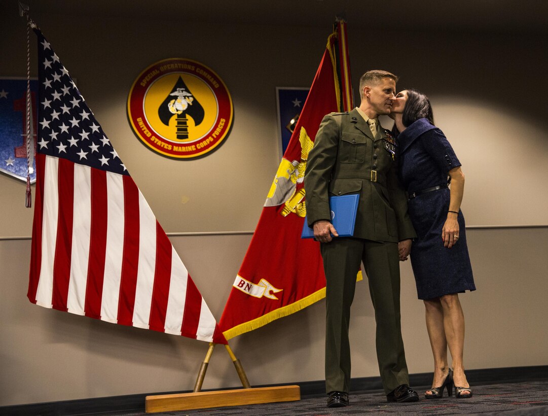 Jennifer McDonald kisses her husband Maj. Robb McDonald after he is awarded the Silver Star for his actions in Camp Bastion, Afghanistan. Maj. McDonald receives the Silver Star, the nation’s third-highest combat valor award, for his role in repelling an enemy attack inside Camp Bastion, Afghanistan. McDonald was serving as the executive officer of Marine Attack Squadron 211, III Marine Aircraft Wing. The ceremony took place at the 1st Marine Special Operations Battalion command building at Camp Pendleton Dec. 9. 

According to the award citation on Sept. 14, 2012 15 insurgents infiltrated Camp Bastion and attacked the coalition forces stationed there. McDonald took charge after the commanding officer, Lt. Col. Christopher Raible, was mortally wounded. He risked his life to lead Marines away from a building that could have become a death trap had the troops remained there. He later shot and killed one attacker and directed two helicopter attacks that killed several other insurgents.